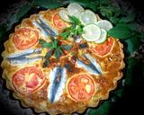 A picture of step 4 of Sardine quiche, sliced ​​tomatoes.