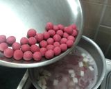 A picture of step 6 of Hibiscus Thai rice balls dunk in coconut milk.