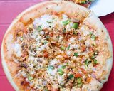 A picture of step 7 of Chicken Tikka pizza.