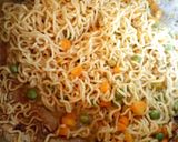 A picture of step 10 of Jollof Vegetable noodles with fried eggs.