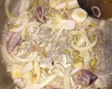 A picture of step 2 of Fish peepered soup garnish with parsely.