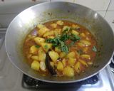 A picture of step 2 of Gujarati lunch (rasadar aloo sabji, amrakhand, puri, dal, rice).
