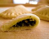 A picture of step 3 of Dumplings (pierogi) with spinach.