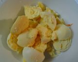 A picture of step 10 of Buttery broccoli salad topped with deviled eggs.