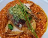 A picture of step 7 of Tomato and chorizo risotto with pan fried chicken supreme and pesto compound.
