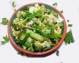 A picture of step 8 of Fried rice topped with green veggies.