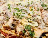 A picture of step 8 of Loaded Nachos with Mango Salsa, Sour cream and cheese sauce.
