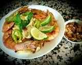 A picture of step 3 of Pad thai with king prawns and lemon slices and tagliatelle rice.