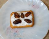 A picture of step 1 of Tuc with fresh cream and date.