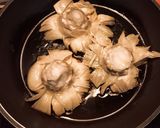 A picture of step 5 of Grilled Artichokes with Garlic, Oil, and Parsley Dressing.