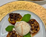 A picture of step 5 of Baked Peaches with Amaretti, Dark Chocolate, Ice Cream and Mint.
