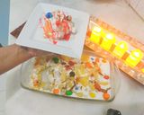 A picture of step 6 of Pineapple delight with m&m bunties.