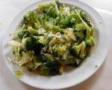 A picture of step 7 of Fried rice topped with green veggies.