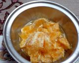 A picture of step 3 of Orange wedges icecream.
