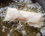 A picture of step 8 of Moong Dal Halwa Cigars dipped in Shaahi Rabdi.