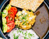 A picture of step 4 of Malai Boti with sheermaal and chutney.