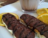 A picture of step 15 of Choco orange eclair with fresh cream...cup of hot chocolate.