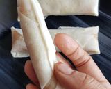 A picture of step 7 of Moong Dal Halwa Cigars dipped in Shaahi Rabdi.