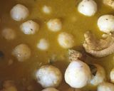 A picture of step 11 of Malabar Kozhi Pidi (rice dumplings in soupy chicken curry).