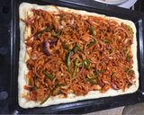 A picture of step 2 of XXL chicken tikka pizza 😋😋😋👌.