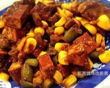 A picture of step 7 of Savory Braised Tofu with Edamame and Corn.