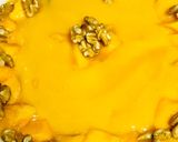 A picture of step 2 of Swiss roll mangoes custard loaded with walnuts.