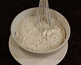 A picture of step 7 of Cinnamon Layer Cake with Whipped Cinnamon Cream Filling and Frosting.