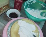 A picture of step 3 of Vanilla cream cake with chocolate chips inside.