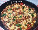 A picture of step 6 of Shakshuka with Eggs and Cheese.