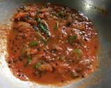 A picture of step 5 of Chatpata Bread Upma in red sauce.