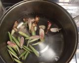 A picture of step 2 of Clear Tom Yum Soup with Three Mushrooms (Vegetarian).
