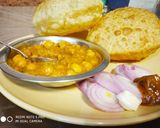 A picture of step 6 of Masala poori with white chana.