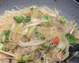 A picture of step 8 of Thai style Stir-fried rice noodles with chicken and sausages.