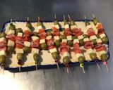A picture of step 6 of Appetizer Skewers with Green Olives, Tomato, Prosciutto, and Pyrenees Cheese.