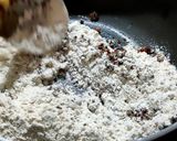 A picture of step 1 of Wheat flour seeds and nuts Ladoo with leftover ghee residue.