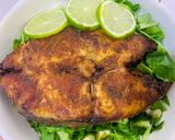 A picture of step 12 of Baked Tilapia Fish served with rocket leaves.