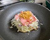 A picture of step 3 of Omu-Okonomiyaki (Japanese as-you-like pancake wrapped with egg).