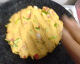 A picture of step 2 of Makke ki roti with green garlic leaves.