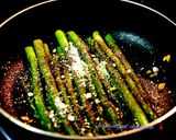 A picture of step 5 of Burnt garlic aspagauraus topped with parmesan cheese.