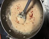 A picture of step 2 of Mix pasta in white sauce.