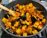 A picture of step 12 of Eggplant Curry with Mushrooms, Tomatoes, and Coconut Milk.