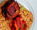 A picture of step 10 of Ghanaian vegetable Jollof rice with red seasoned chicken.