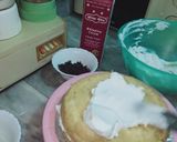A picture of step 4 of Vanilla cream cake with chocolate chips inside.