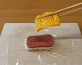A picture of step 9 of Pork, Egg, Avocado & Tuna Onigiri.