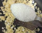 A picture of step 9 of Coconut Mawa balls immersed in Creamy Coconut saffron milk.
