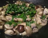 A picture of step 3 of Sauteed mushrooms and wilted spinach in garlic butter.