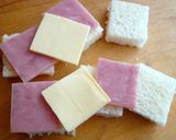 A picture of step 2 of Fruit, Cheese, and Ham Sandwich Skewers.
