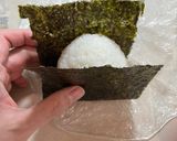 A picture of step 4 of Onigiri with bonito flakes and cheese.