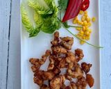 A picture of step 7 of Beer-battered pork popcorn served with sticky rice and sweet chilli sauce, on little gem.