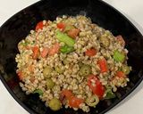 A picture of step 5 of Farro Salad with Pesto, Iceberg Lettuce, Basil, Green Olives, Tomatoes, and Tuna.